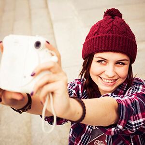 Woman Taking A Selfie With Polaroid Camera