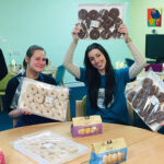 Espares Team Holding Donuts In John Taylor Canteen