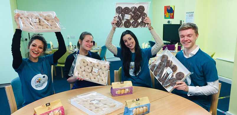 Espares Team Holding Donuts In John Taylor Canteen