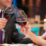 Couple Holding Wine Glasses On Date