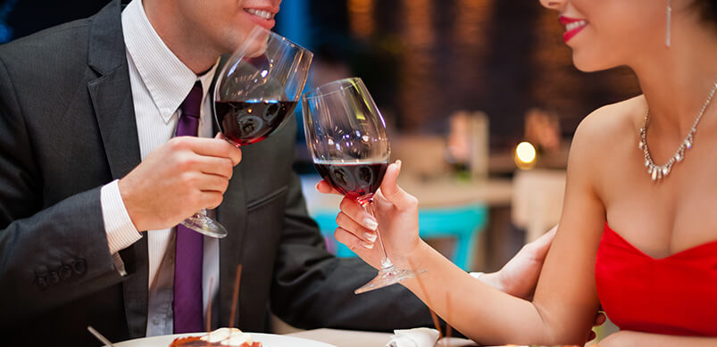 Couple Holding Wine Glasses On Date