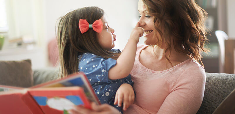 Woman Reading Story To Young Girl