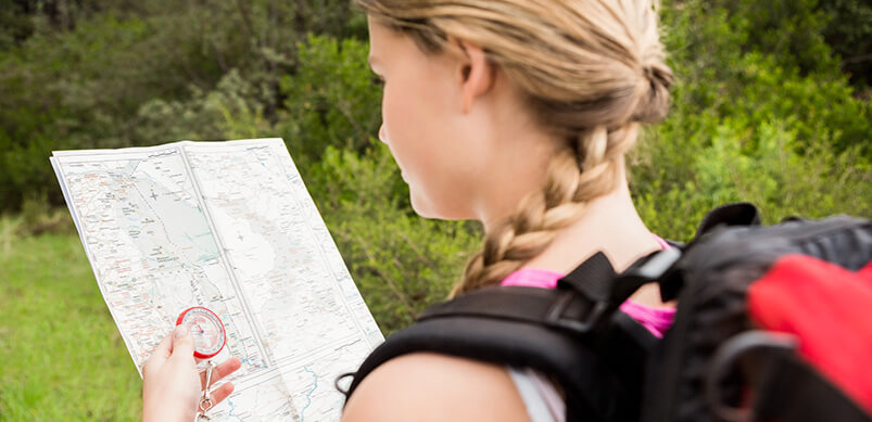 Girl Reading Map With Rucksack