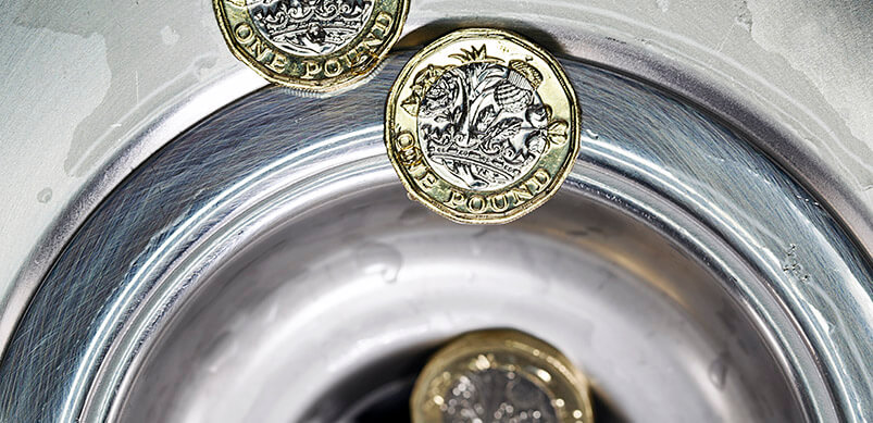 Pound Coins Being Rinsed Down Drain