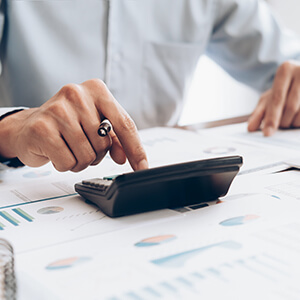 Man Working Out Finances On Calculator