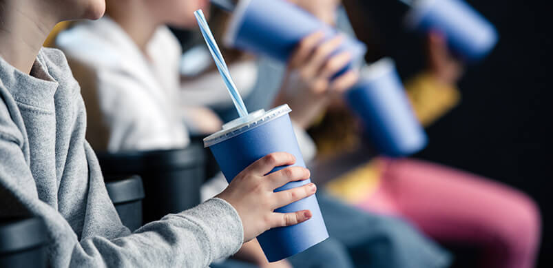 Children Watching Film With Drinks