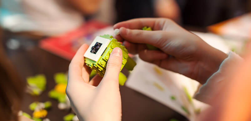 Close Up Of Hands Playing With Lego