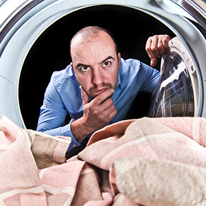 Man Looking Inside Washing Machine