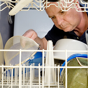 Man Looking Inside Dishwasher