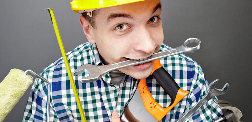 Man Holding Lots Of Tools 