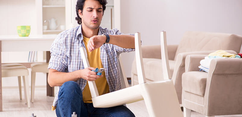 Man Reparing Furniture And Checking Time