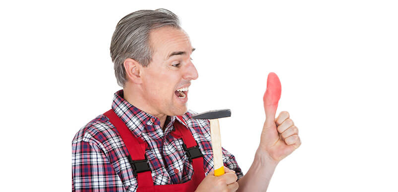 Man Holding Hammer With Injured Thumb