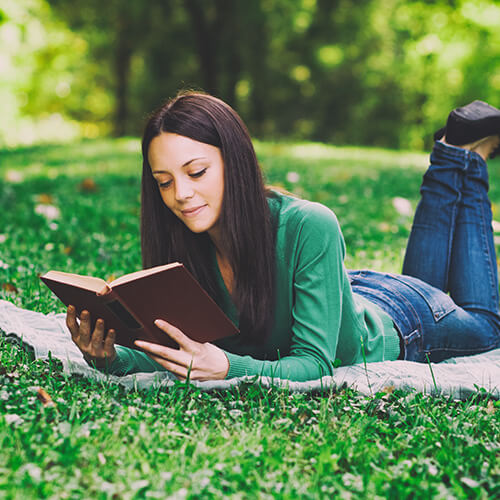 Woman Reading Book In The Park