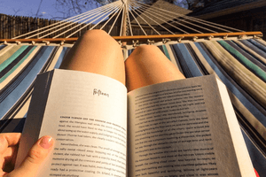 Person in hammock reading book