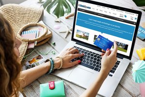 Woman on computer with bank card