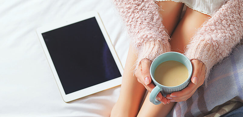 Woman Relaxing With Tea And Tablet