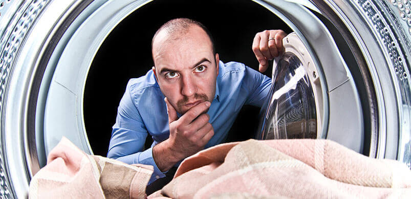 Man Looking Inside Washing Machine