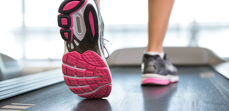 Person's Trainers On Treadmill