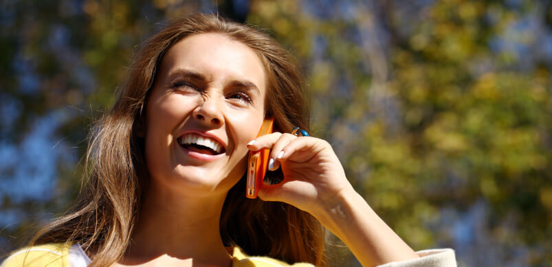 Woman Smiling On Mobile Phone