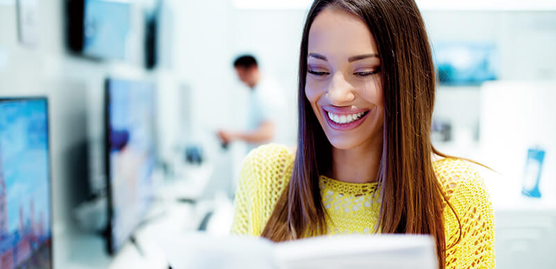 Woman Smiling Reading Manual