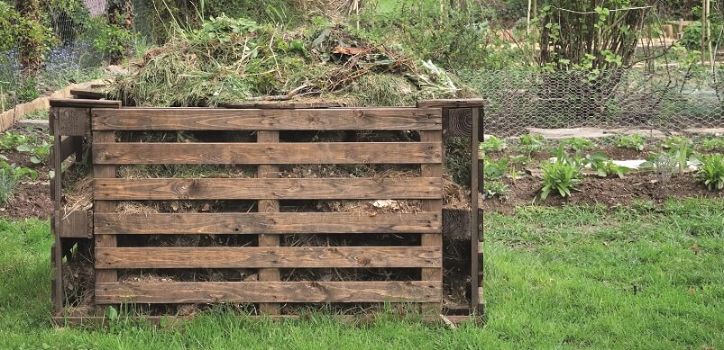 Wooden Compost Heap In Garden