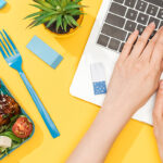 Person Working On Laptop With Lunch