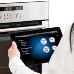 Woman Controlling Appliances With Tablet