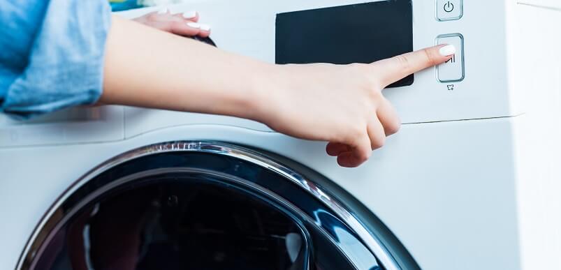 Person Turning Washing Machine On 