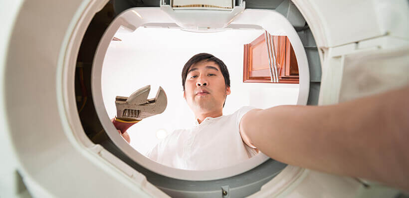 Man Repairing His Washing Machine Himself