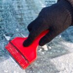 Person Scraping Ice From Car