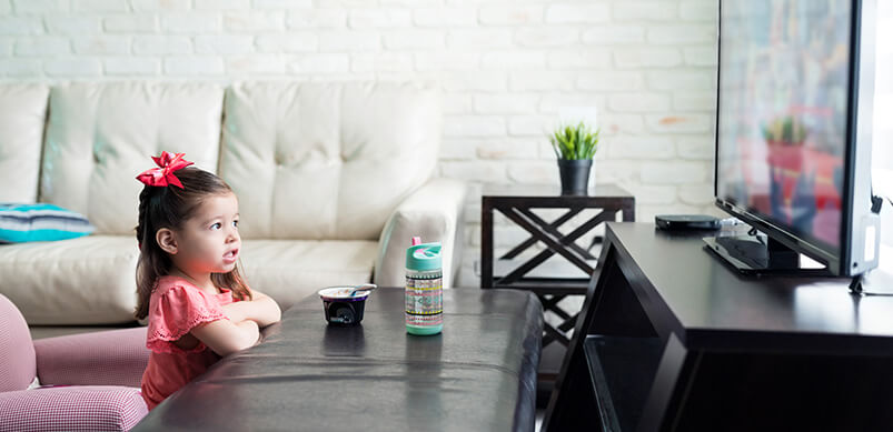 Child Watching TV In Living Room