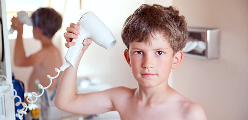 Child Drying Hair In Bathroom