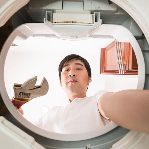 Man Fixing Washing Machine