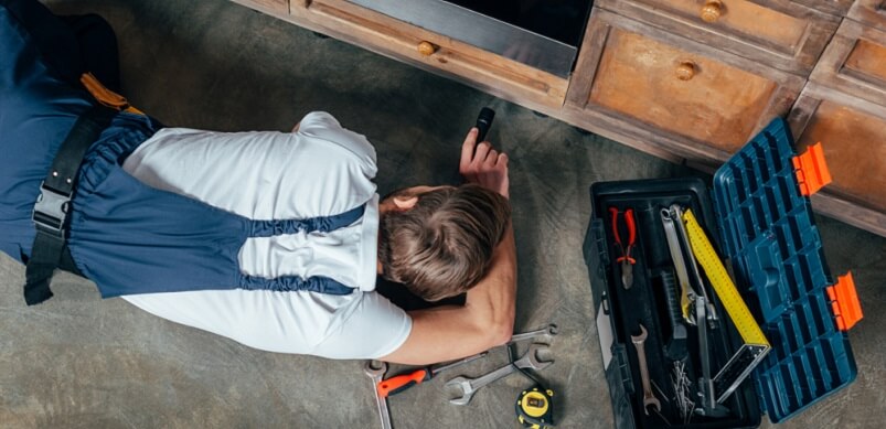 Young Man Fixing Oven