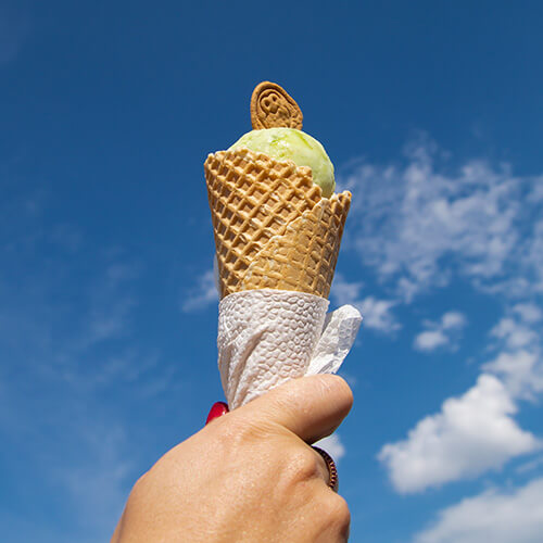 Hand Holding Ice Cream To Sky