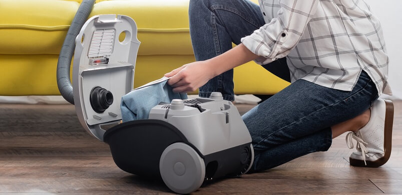 Woman Changing Vacuum Filter