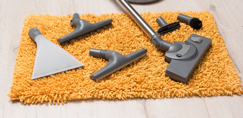 Vacuum cleaner nozzles on yellow carpet