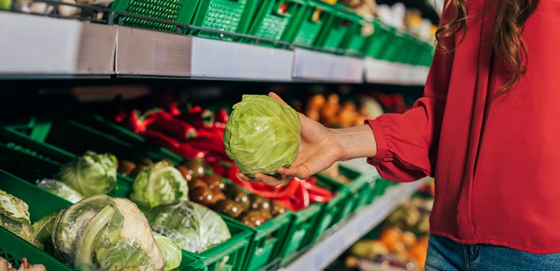 Woman in fresh vegetable aisle