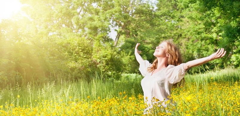 Woman enjoying the sun in a field