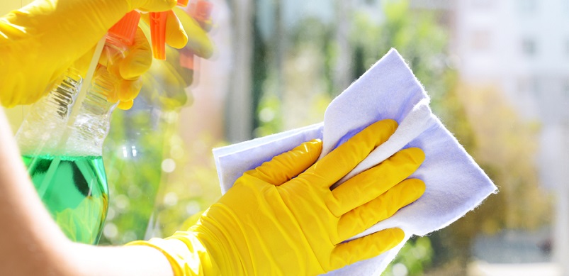 Gloved hand wiping a window